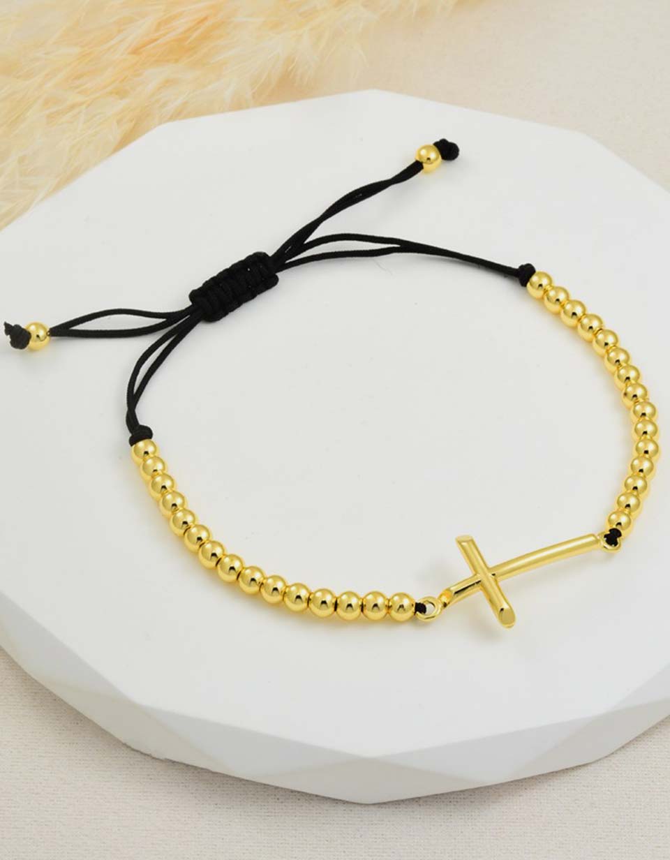 Pulsera con cruz y esferas doradas