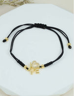 Pulsera con dije LOVE y piedras brillantes