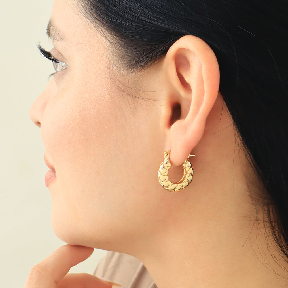 Aretes tipo argolla dorados con textura de escamas